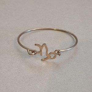 Gold Colored Bangle with Capricorn Symbol